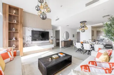 a living room with a couch and a table at Luxury 4BR with Hermes Touch & Burj Khalifa View in Dubai