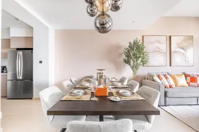 a dining room with a table and chairs at Luxury 4BR with Hermes Touch & Burj Khalifa View in Dubai