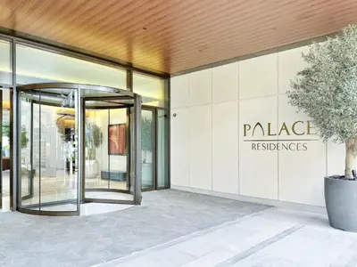 an entrance to a building with a glass revolving door at Palace residence creek harbour in Dubai