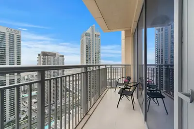 a balcony with chairs and a view of the city at Elegant Creekside 1BR with Panoramic Views in Dubai