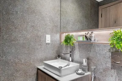 a bathroom with a sink and a mirror at Waves - Elegant & Lavish Studio Apt for 4 in JVC in Dubai