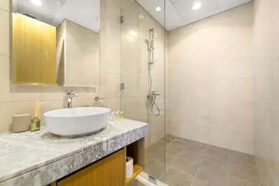 a bathroom with a sink and a shower at Silkhaus Elite 2BR near Safa Park in Aykon City in Dubai