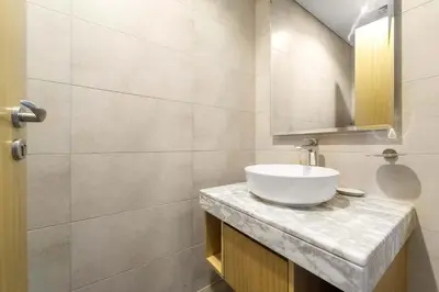 a bathroom with a white sink and a mirror at Silkhaus Elite 2BR near Safa Park in Aykon City in Dubai