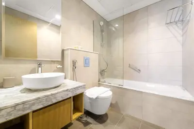 a bathroom with a sink and a toilet and a shower at Silkhaus Elite 2BR near Safa Park in Aykon City in Dubai