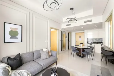 a living room with a couch and a table at Silkhaus Elite 2BR near Safa Park in Aykon City in Dubai