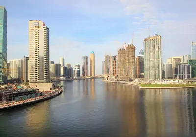 a view of a city with a river and buildings at Modern Canal View with Balcony Damac Prive Dubai in Dubai