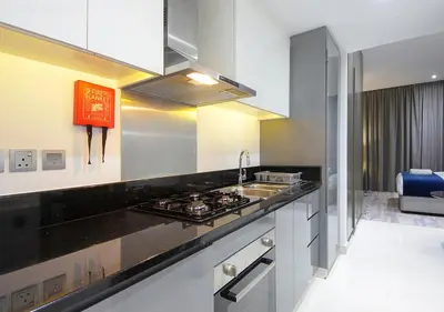 a kitchen with a sink and a stove at Modern Canal View with Balcony Damac Prive Dubai in Dubai