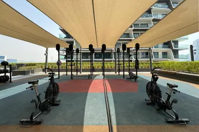 a group of exercise bikes parked under a building at Luxe 2 Bedroom with Burj Khalifa and Canal Views in Dubai