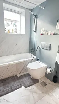 a bathroom with a toilet and a bath tub at Metro Access,Insulated in Dubai