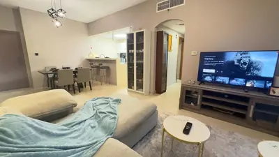 a living room with a couch and a flat screen tv at Metro Access,Insulated in Dubai