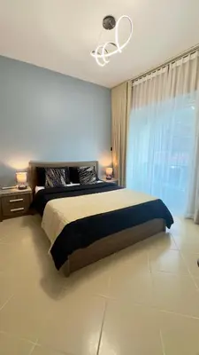 a bedroom with a large bed and a window at Metro Access,Insulated in Dubai