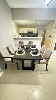 a table and chairs in a room with a kitchen at Metro Access,Insulated in Dubai
