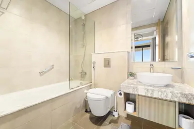 a bathroom with a toilet and a sink and a shower at Silkhaus Spacious 2BR in Aykon City Near Safa Park in Dubai