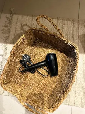 a wicker basket with a black object in it at The Designers Apartment Dubai Marina in Dubai