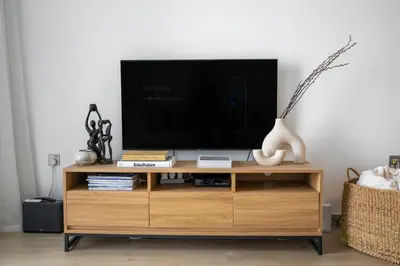 a tv on a wooden entertainment center in a living room at The Designers Apartment Dubai Marina in Dubai