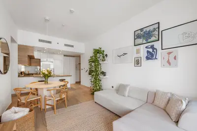 a living room with a white couch and a table at The Designers Apartment Dubai Marina in Dubai