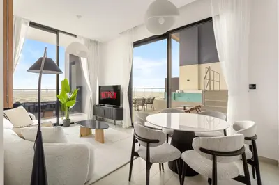 a living room with a table and chairs at VayK - Luxury 2BR with Jacuzzi in JVC in Dubai