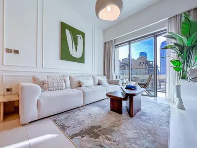 a living room with a couch and a table at Spectacular Burj Khalifa View, 2BR Luxury Apartment by SBH in Dubai