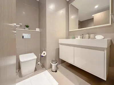 a bathroom with a white toilet and a sink at Spectacular Burj Khalifa View, 2BR Luxury Apartment by SBH in Dubai