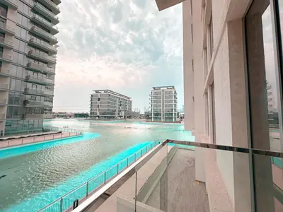 a view of the water from a balcony of a building at Luxury 1BR with Aquatic View, District One in Dubai