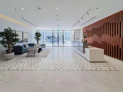 a lobby with a couch and chairs and a table at Luxury 1BR with Aquatic View, District One in Dubai