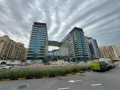 a parking lot with two tall buildings in a city at Dubai Palm Jumeirah - Free Infiniti Pool and Private Beach in Dubai