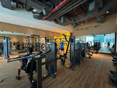 a gym with several treadmills and people in the gym at Dubai Palm Jumeirah - Free Infiniti Pool and Private Beach in Dubai