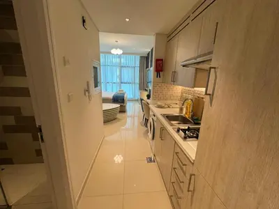 a kitchen with white cabinets and a stove top oven at Dubai Palm Jumeirah - Free Infiniti Pool and Private Beach in Dubai