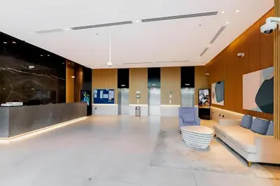 an office lobby with a couch and a table at Dubai Palm Jumeirah - Free Infiniti Pool and Private Beach in Dubai