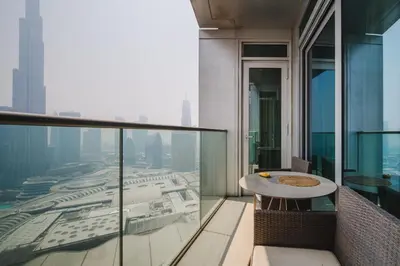 a balcony with a table and a view of a city at Address Dubai Mall Residences in Dubai