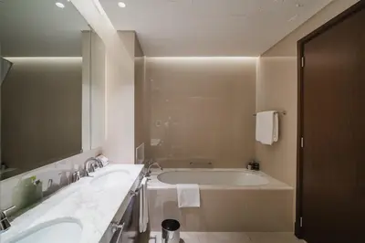 a bathroom with two sinks and a large mirror at Address Dubai Mall Residences in Dubai