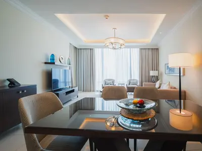a living room with a table with a cake on it at Address Dubai Mall Residences in Dubai
