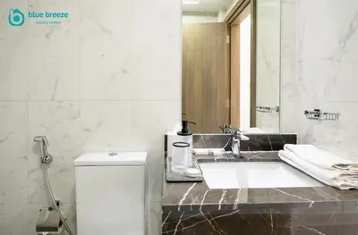 a bathroom with a sink and a mirror at Blue Breeze - Elegant Studio in Serenity Lake 5, JVC in Dubai