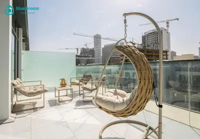a hanging chair on the roof of a building at Blue Breeze - Elegant Studio in Serenity Lake 5, JVC in Dubai