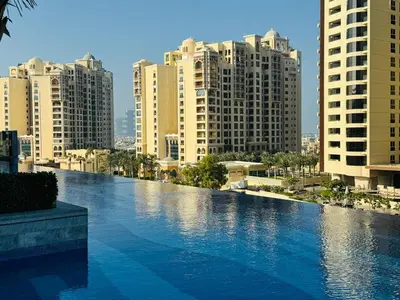 a swimming pool in a city with tall buildings at Sea View Apartment by St Regis 5 stars Infinity Pool in Dubai