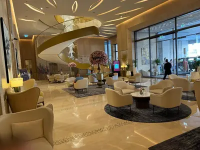 a lobby of a hotel with chairs and tables at Sea View Apartment by St Regis 5 stars Infinity Pool in Dubai