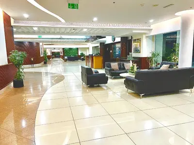 a lobby with couches and chairs in a building at Stunning 2BR Marina View Apt Close to JBR in Dubai