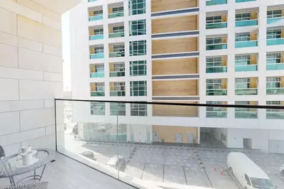 a view of a building from a glass balcony at O Ten Al Jaddaf - Stylish Studio in Dubai