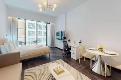 a living room with a bed and a dining table at O Ten Al Jaddaf - Stylish Studio in Dubai