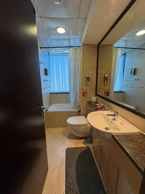 a bathroom with a sink and a toilet and a mirror at Click Stay - JLT - 2 Bedroom & Balcony Lakes View Entire Apartment -SS in Dubai