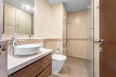 a bathroom with a sink and a toilet and a shower at Apartment in Downtown Dubai in Dubai
