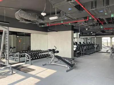 a gym with rows of exercise bikes and treadmills at Vayk - Spacious 1BR Apartment in Dubai Hills in Dubai