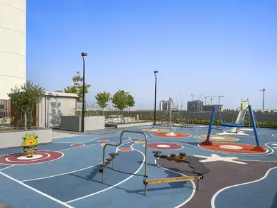 a playground with a basketball court in a park at Vayk - Spacious 1BR Apartment in Dubai Hills in Dubai