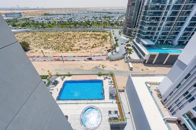an overhead view of a swimming pool in a building at Vayk - Spacious 1BR Apartment in Dubai Hills in Dubai