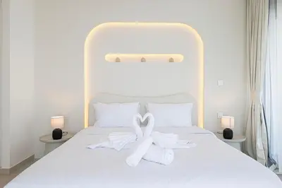 a white bed with two white towels on it at Luxury Stay Burj Views and Direct Dubai Mall Access in Dubai