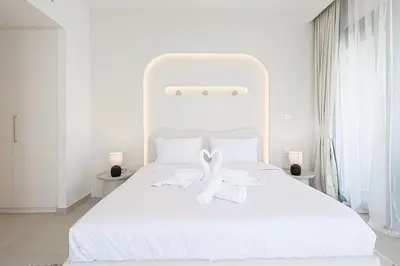 a white bed with two white towels on it at Luxury Stay Burj Views and Direct Dubai Mall Access in Dubai