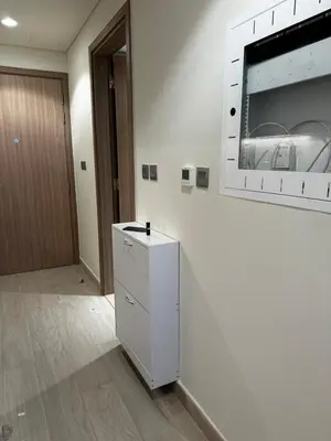 a white refrigerator in a room with a door at Sunlit serenity Studio Azizi Riviera in Dubai