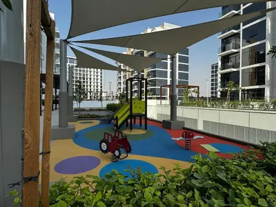 a play area with a playground in a building at Sunlit serenity Studio Azizi Riviera in Dubai