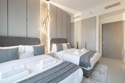 two beds in a hotel room with at Gogoto1 Ultra LUX Burj View Spacious High Floor PS5 NYE Fireworks View in Dubai