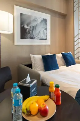 a hotel room with a table with fruit on it at Damac Maison Prive, Lake View - Free Parking in Dubai